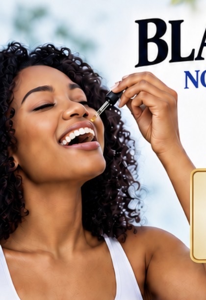 Woman using black seed oil with a dropper